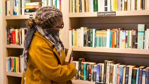 Visitor browsing the shelves of a secondhand bookshop